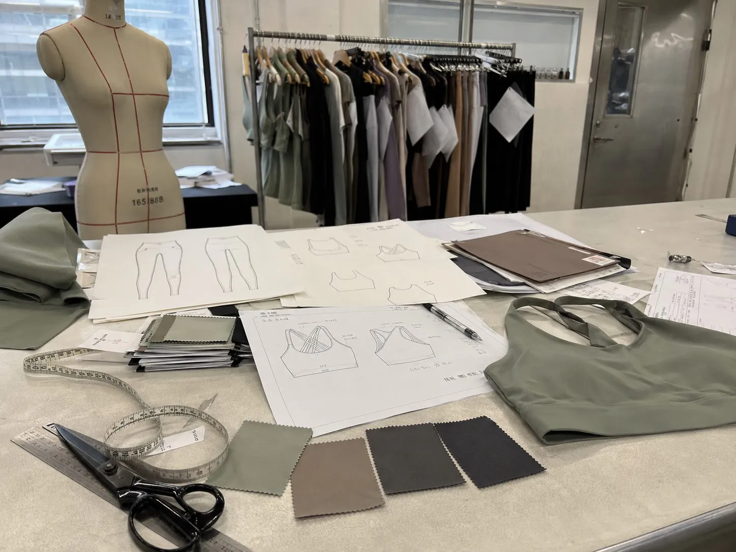 Activewear samples, patterns and fabric swatches on a sample-room worktable
